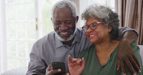 Elderly couple video calling family during isolation