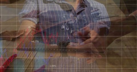 Carpenter analyzing data on smartphone in workshop environment