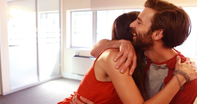 Romantic couple embracing each other in office