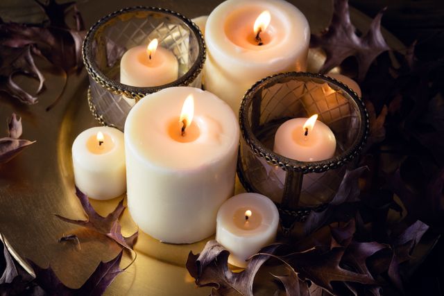 Lit Candles with Autumn Leaves on Table - Download Free Stock Photos Pikwizard.com