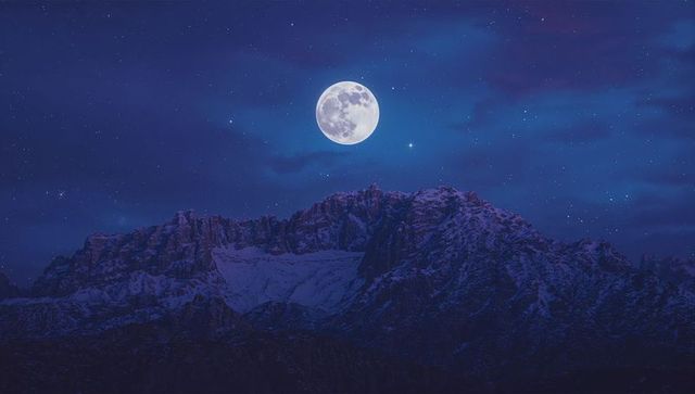 Full Moon Illuminating Majestic Mountains at Night