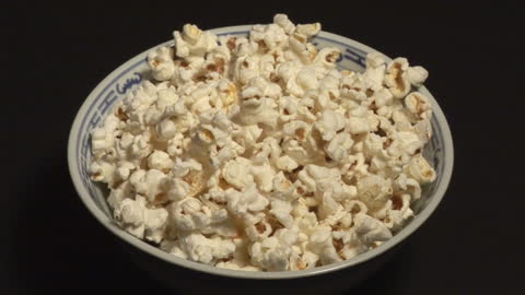 Bowl of Freshly Popped Popcorn on Dark Background