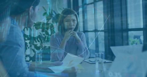 Business team analyzing financial data with digital interfaces