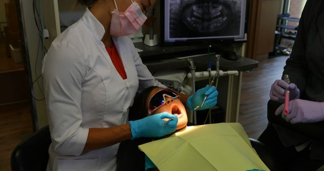 Female Dentist Examining Child Patient in Dental Clinic - Download Free Stock Images Pikwizard.com