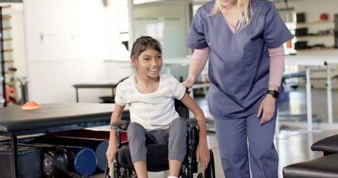 Child with cerebral palsy receiving assistance from therapist