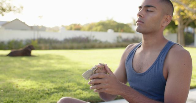 Young Man Meditating Outdoors with Mala Beads in Green Park - Download Free Stock Images Pikwizard.com