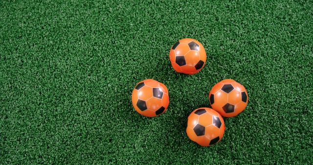 Orange and Black Soccer Balls on Green Artificial Turf - Download Free Stock Images Pikwizard.com