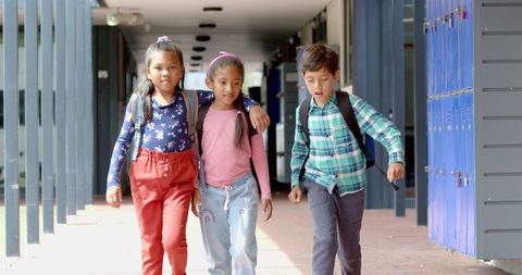 Three Biracial Students Walking Corridor Together - Download Free Stock Images Pikwizard.com