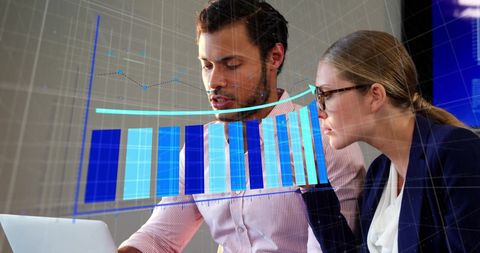 Business Professionals Analyzing Financial Data with Digital Graphs