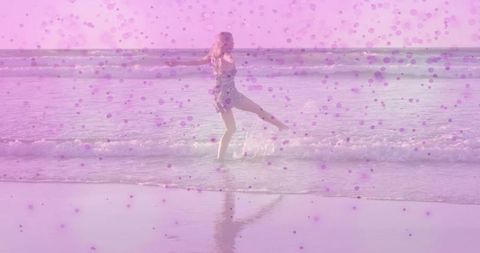 Woman Balancing in Ocean With Artistic Pink Dot Overlay