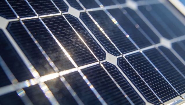 Close-up Photovoltaic Cells Reflecting Sunlight with Silver Busbars for Renewable Energy