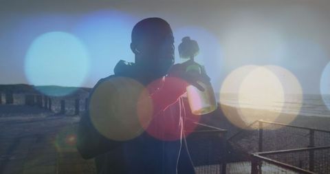 Athlete Outdoors Drinking Water Against Bright Sunset