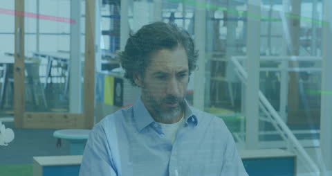 Senior Man Analyzing Data on Laptop in Modern Office