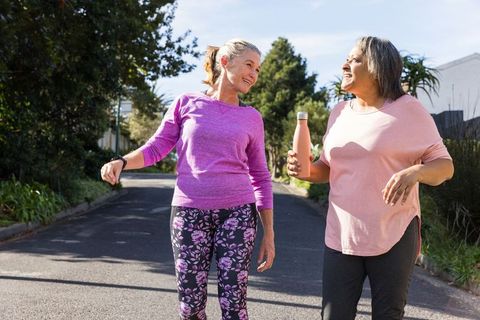 Senior Friends Enjoying Outdoor Walk in Residential Neighborhood