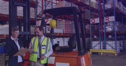 Warehouse team conducting inventory inspection with forklift, safety vests and helmet
