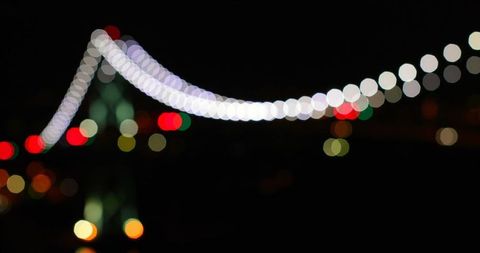 Abstract bokeh lights of suspension bridge at night