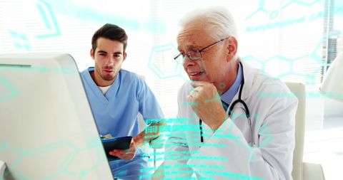 Medical Professionals Analyzing Biological Data on Monitor in Clinic