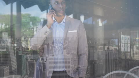 Businessman Overlooking Cityscape While On Call