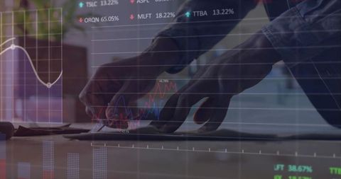 Typing Hands Analyzing Financial Data with Overlaid Stock Market Charts and Analytics