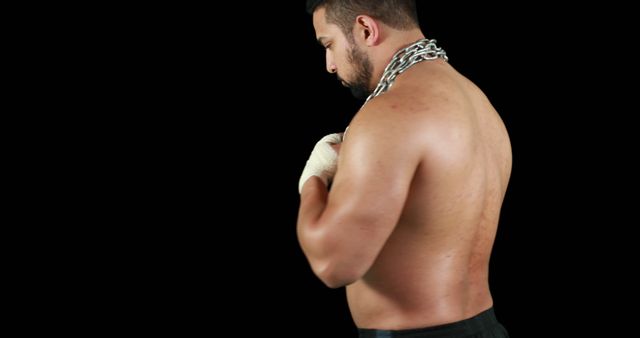 A muscular Caucasian man exudes strength by posing with a heavy chain for a fitness theme. - Download Free Stock Photos Pikwizard.com