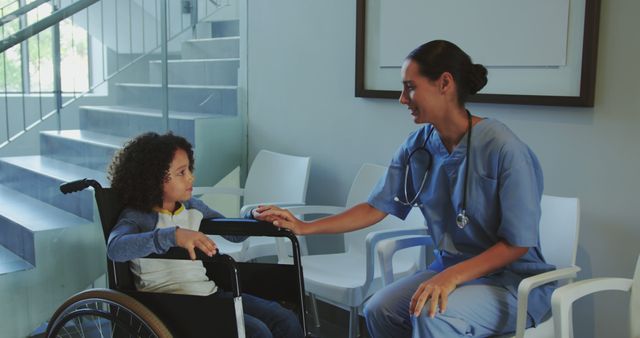 Nurse talking to child in wheelchair in modern clinic - Download Free Stock Images Pikwizard.com