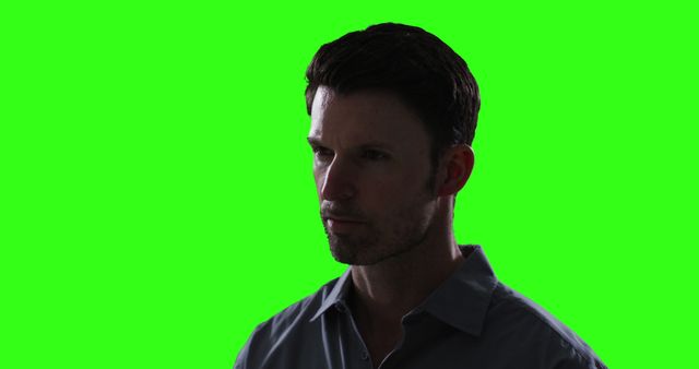 Man depicted in thoughtful pose against a green screen background is useful for easily adding custom backgrounds for advertisements, promotional banners, digital projects, or website hero sections highlighting design versatility.