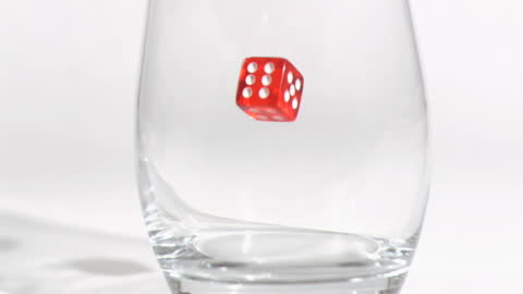 Red Dice in Slow Motion Inside Glass