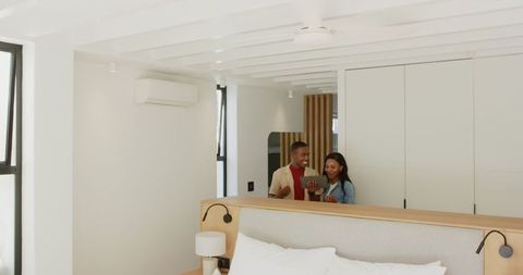Couple Using Tablet Together in Modern Minimalist Bedroom