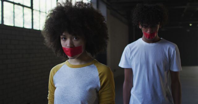 Teens with Red Tape on Mouths in Urban Setting - Download Free Stock Images Pikwizard.com