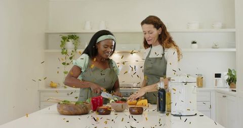Friends Cooking Together in Bright Kitchen Celebrating with Confetti and Fresh Produce