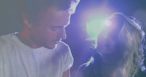 Singing Duet Performing on Stage with Hazy Lighting