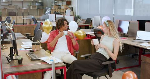 Colleagues celebrating with a relaxed office party atmosphere