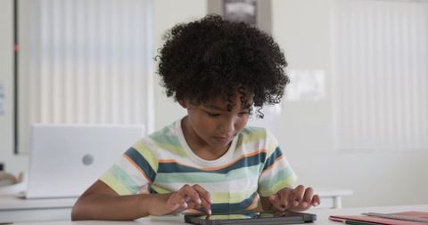 African American Boy Using Tablet for Remote Learning and Studying at Home