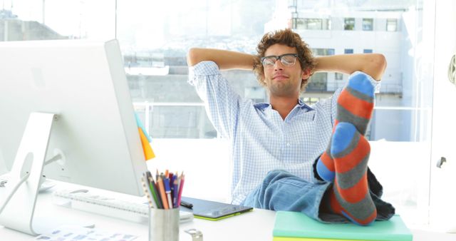 Relaxed Man Taking a Break at Office Desk Wearing Casual Socks - Download Free Stock Images Pikwizard.com