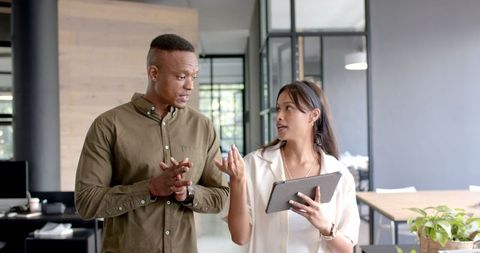 Colleagues discussing business strategy using digital tablet