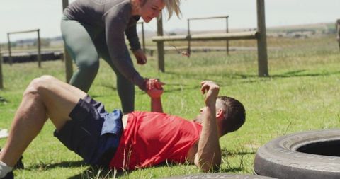 Runner helping teammate up after training fall