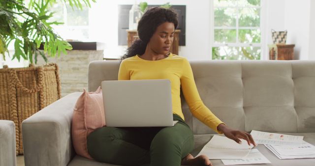 Woman Working on Laptop Sitting on Sofa Analyzing Documents - Download Free Stock Images Pikwizard.com