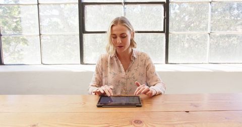 Businesswoman Using Tablet in Modern Bright Office