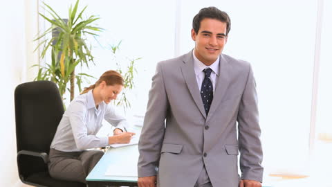 Confident Businessman Smiling in Office Environment
