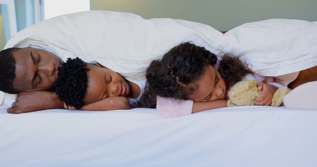 Father Sleeping with Children on Bed Under Blanket - Download Free Stock Images Pikwizard.com