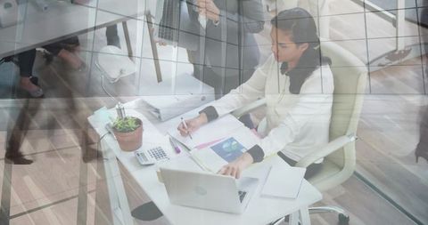 Middle eastern woman analyzing data in modern office