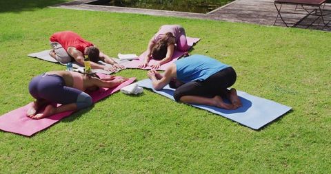 Diverse Group in Child's Pose at Outdoor Yoga Session