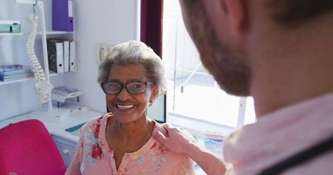 Senior Woman Smiling with Doctor in Clinic