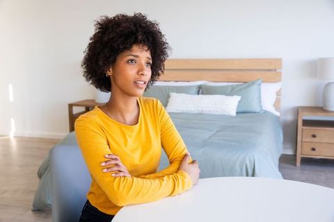Woman Sitting at Table in Cozy Modern Bedroom