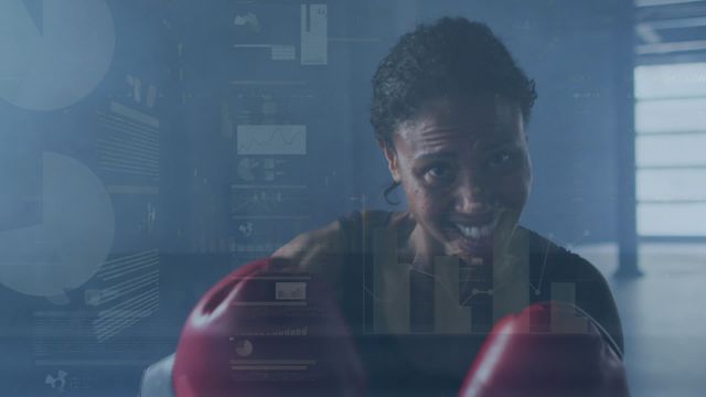 This dynamic scene captures a determined African female boxer training, intertwined with graphic overlays of data, charts, and graphs. These digital elements emphasize athletic performance, modern health analytics, and the intersection of technology and sport. This visual could be used to illustrate themes in fitness blogs, digital marketing for sports tech products, or promotional material for gyms and training apps focused on data-driven progress.