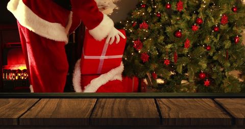 Santa Claus Delivering Gifts by Christmas Tree at Cozy Night - Download Free Stock Images Pikwizard.com
