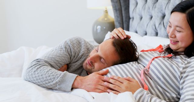 Happy couple expecting baby enjoying peaceful moment in bed - Download Free Stock Images Pikwizard.com