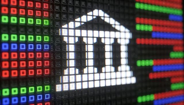 Pixelated bank icon glowing on macro rgb led panel with colorful grid and circuitry