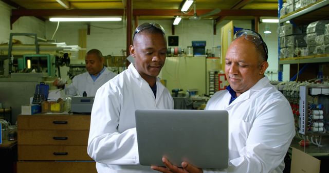 Engineers Analyzing Data on Laptop in Industrial Workspace - Download Free Stock Images Pikwizard.com