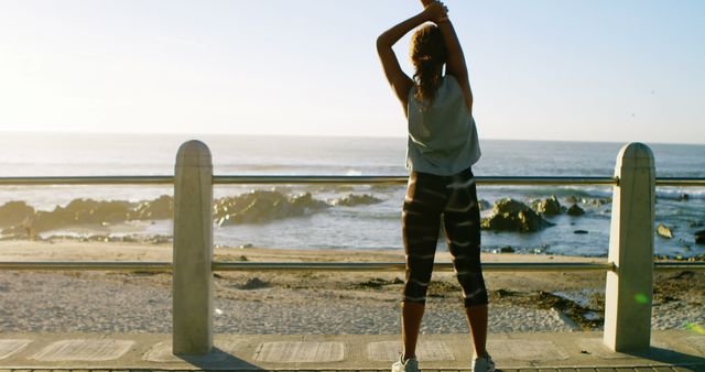 Woman Stretching by Oceanfront at Sunrise - Download Free Stock Images Pikwizard.com